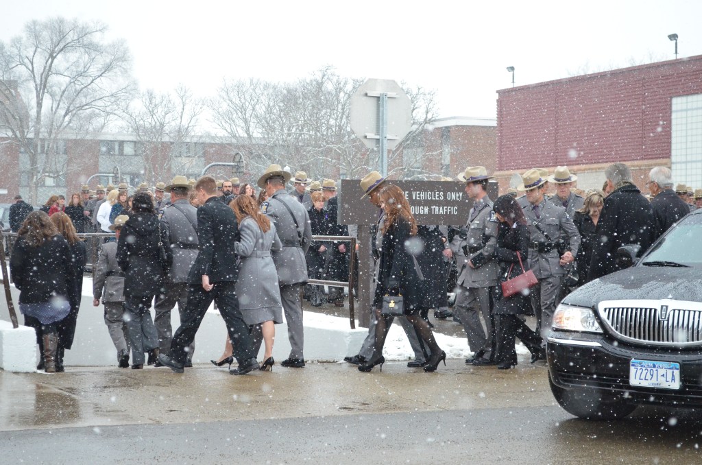 ST. BONAVENTURE, N.Y. (Nov. 26, 2013) ––&nbsp;Troopers and their families join the procession into the Reilly Center Arena for Trooper Ross Riley's funeral.